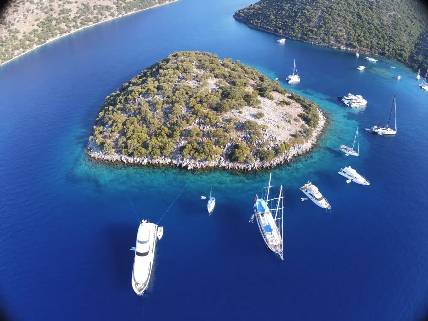 Drone view of a yacht anchored near a small island